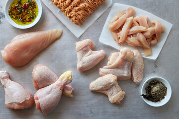 Raw chicken on table with seasoning