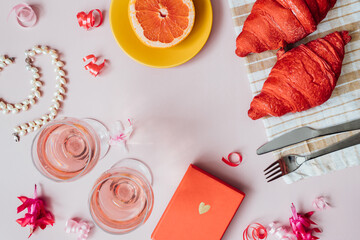 top view, close-up, festive romantic breakfast on a pink background for valentine's day, two red...