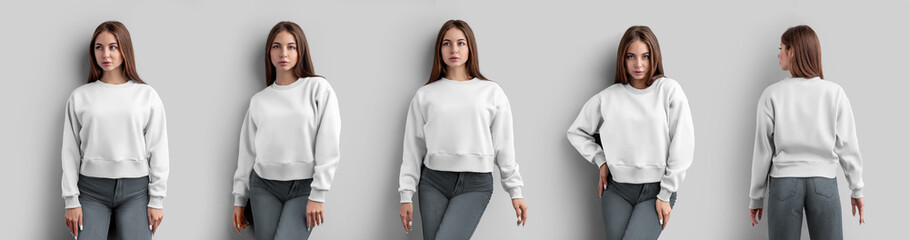 Mockup of a white crop sweatshirt on a beautiful girl in gray jeans, isolated on background, front,...