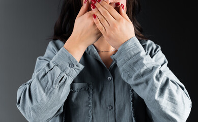 Woman covering her mouth with her hands