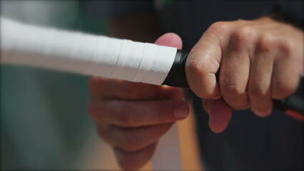 Player changing racquet tennis grip. Person replacing overgrip closeup hand renewing sport equipment