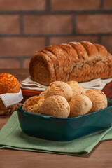 Cheese breads in a serving dish with wholemeal bread behinden.