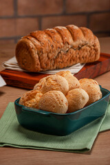 Cheese breads in a serving dish with wholemeal bread behinden.