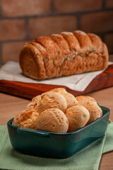 Cheese breads in a serving dish with wholemeal bread behinden.