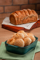 Cheese breads in a serving dish with wholemeal bread behinden.