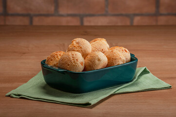 Cheese breads in a serving dish on wooden table