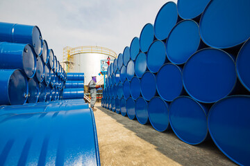 Male worker inspection record drum oil stock barrels blue horizontal or chemical