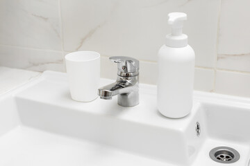Faucet and white sink in a modern bathroom.