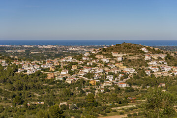 Fototapeta na wymiar Beautiful panorama overlooking a distant town with the sea and forest in the background