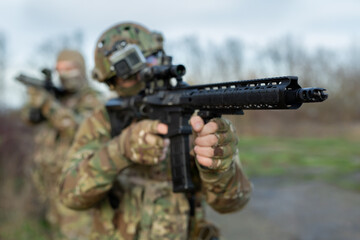 Two military man with airsoft automatic rifle.