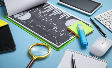 Magnifying glass financial graphs and other business objects.