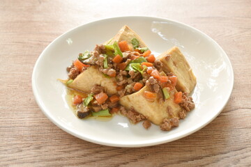 steamed white tofu topping mashed pork and vegetable gravy sauce on plate
