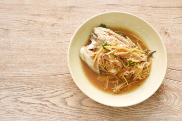 steamed bass fish dressing soybean gravy sauce topping slice ginger and mushroom on plate