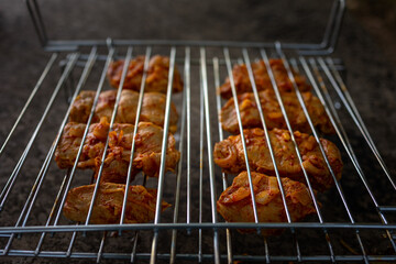 Mouth-watering pieces of steak marinated for barbecue in the grill before the start of the party.