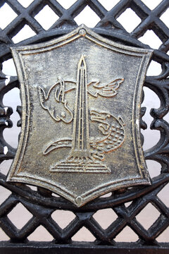 The logo of the Surabaya city government, made of steel, depicts a crocodile and a shark