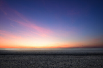 Fototapeta premium Side view of empty tarmac road with dawn sky background.