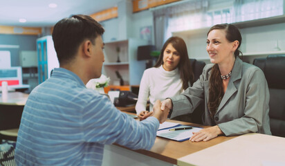 Business with a customer by client service company commercial office. Female financial advisor consulting a client. Women have a business meeting and sign a contract or agreement on negotiations