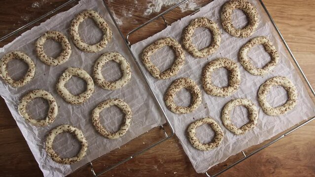 Home baking - making fresh Greek bagels or koulouri of Thessaloniki. Bagel rings rising before going in the oven.