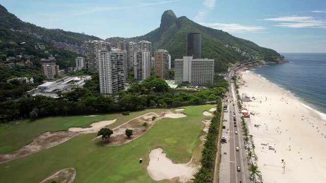 Aerial drone view Above Praia da Gavea in Sao Conrado, Rio de Janeiro, Brazil with luxurious residential buildings and golf course visible