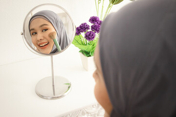 View from mirror. Asian muslim woman beauty blogger tutorial cosmetics flower blush techniques products for her vlog and blogger