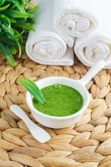 Homemade matcha green tea (kelp, algae, spirulina) face or hair mask (scrub) in a small white bowl....