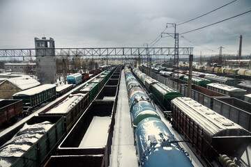 Freight car with coal (empty and loaded) at junction station in cold winter. Energy crisis and...