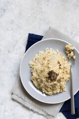 Risotto with porcini mushrooms and black truffles served in a plate top view, gourmet cousine