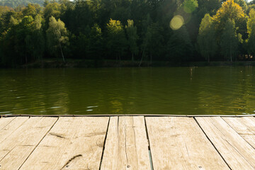 Close-up of dock near lake with forest background