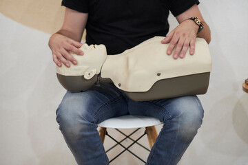 Mannequin for first aid training. First aid cardiopulmonary resuscitation course using automated external defibrillator device, AED.
