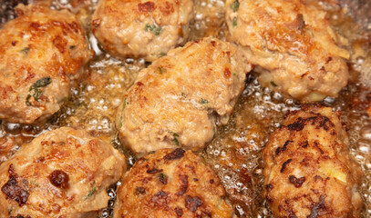 Minced meat cutlets are fried in a frying pan