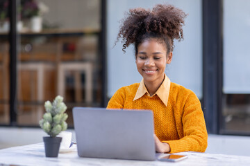 Portrait of Happy smiling african american businesswoman, adorable girl using laptop browsing web drinking coffee in cafe restaurant outdoors