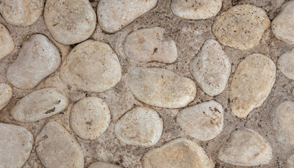 Stones in a concrete wall as an abstract background.