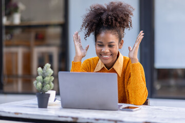 Portrait of Happy smiling african american businesswoman, adorable girl using laptop browsing web drinking coffee in cafe restaurant outdoors