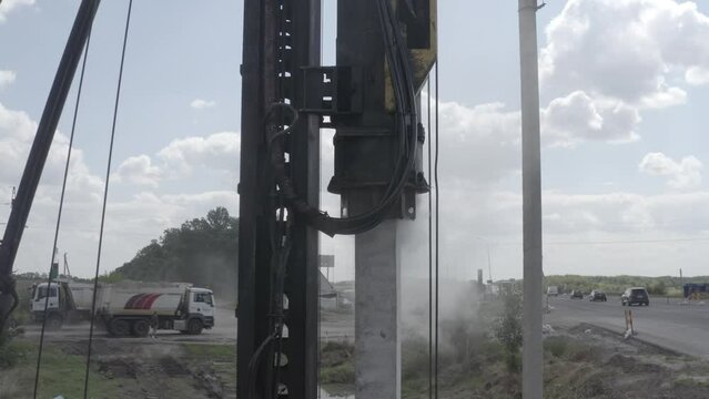 Pile driving machine driving piles into ground site. Modern hydraulic lifting mechanisms. Ukraine. 
