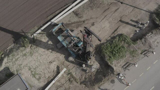 Pile driving machine driving piles into ground site. Modern hydraulic lifting mechanisms. Ukraine. 