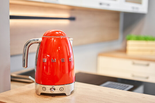 Russia, Nizhny Novgorod - January 21 2022: On kitchen countertop close up in row SMEG brand kitchen appliances for easy life, coffee maker electric teapot popular Italian manufacturer