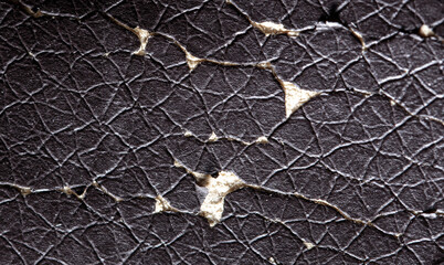 Cracked leather on a chair as an abstract background.