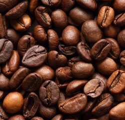 Grains of black coffee as a background.