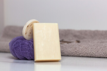 Clean towel and natural handmade soap on white background.