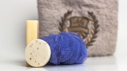 Clean towel and natural handmade soap on white background.