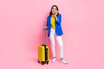 Full length portrait of nice positive person hold suitcase speak communicate telephone isolated on pink color background