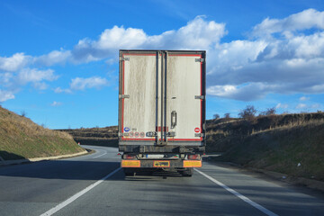Truck in front of the car. The back of the cargo truck.