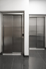 chrome elevators in multi apartment modern house. elevator breakdown. Freight elevator and normal.