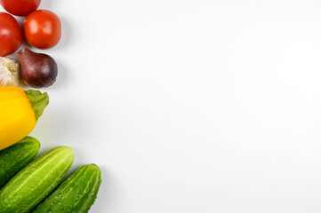 Layout of ripe tomatoes, zucchini, cucumbers on a white background. The concept of cooking, organic vegetables.