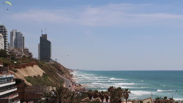 Netanya, sunny beach, city building, paragliding