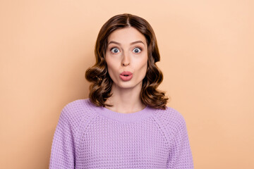 Portrait of astonished ecstatic girl with wavy hairstyle dressed violet pullover staring at discount isolated on pastel color background