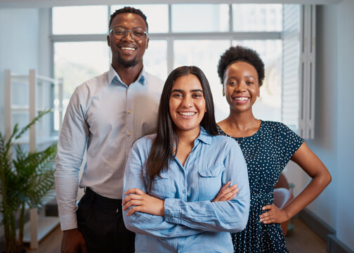 Group Of Smiling Business People Pose Arms Folded In Office, Diverse Trio