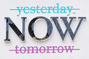 Crossed out words yesterday and tomorrow banner praising the moment of now