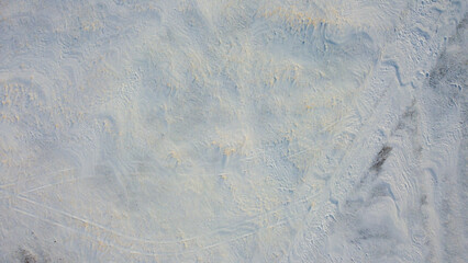 Rolled road through a snowy field