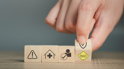 Safety first text yellow and hand flip wooden cube and copy spec. Safety first sign on virtual...